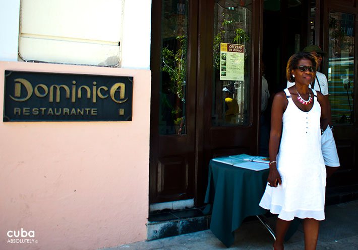 Dominica restaurant in Old Havana, woman with a white dress getting out for the front door © Cuba Absolutely, 2014