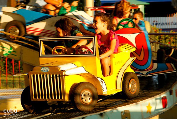 Kids on a small yellow car in Coney Island park in Miramar © Cuba Absolutely, 2014