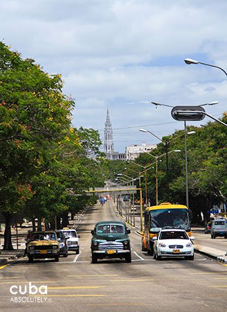 Carlos III avenue with people on the sidewalks, old cars and buses on the street and new and old buildings © Cuba Absolutely, 2014