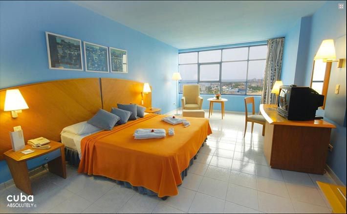 Panorama hotel in Miramar, blue room with yellow bed © Cuba Absolutely, 2014 - 2020