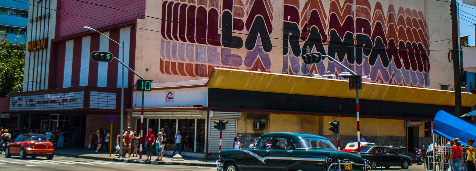 Black old car passing in front of La Rampa