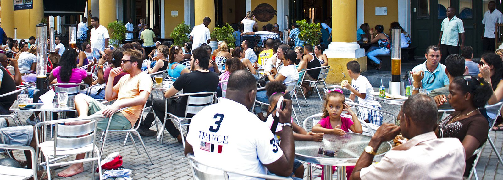 Factoria Plaza Vieja restaurant  in Old Havana, people drinking beer and eating, spanish tavern decoration