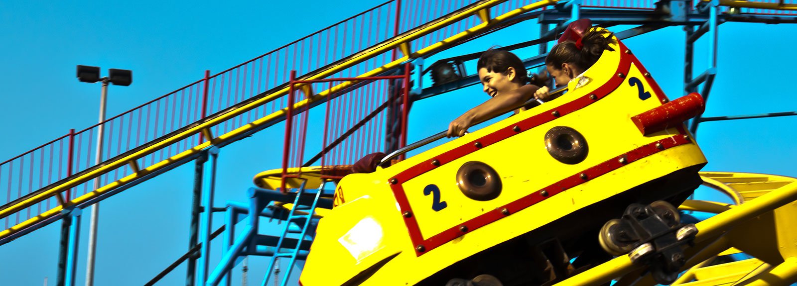 Yellow car at rollercoaster on Coney Island park